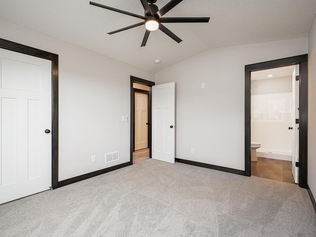 1049 Bellaire Blvd NW, Isanti, MN 55040 - unfurnished bedroom featuring carpet, lofted ceiling, connected bathroom, and a ceiling fan