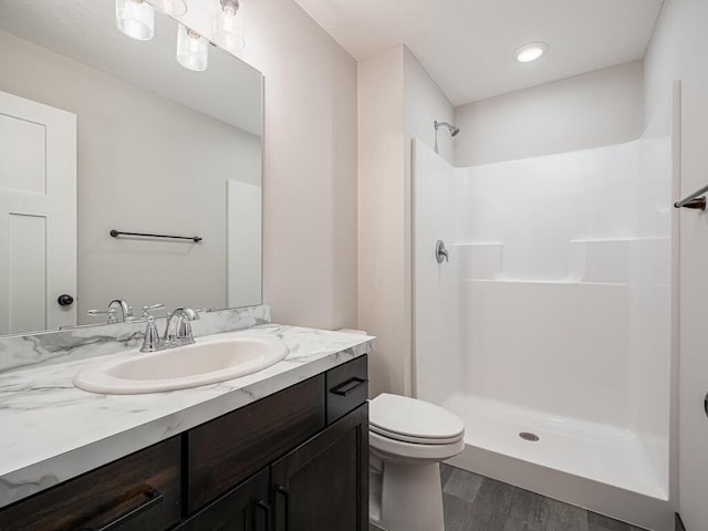 1049 Bellaire Blvd NW, Isanti, MN 55040 - bathroom featuring wood finished floors, vanity, and a shower