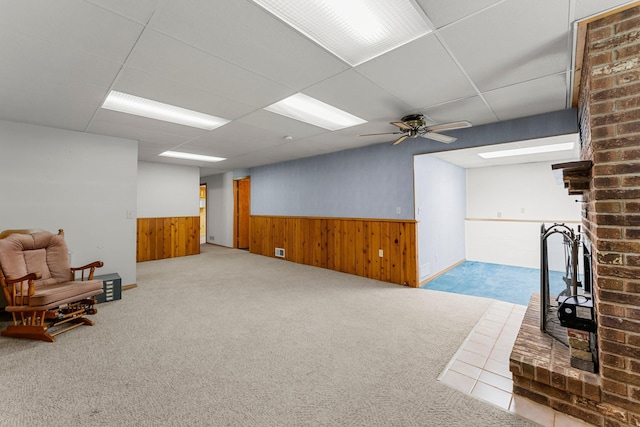 4885 262nd St, Wyoming, MN 55092 - sitting room with wainscoting, carpet flooring, a ceiling fan, wood walls, and a drop ceiling