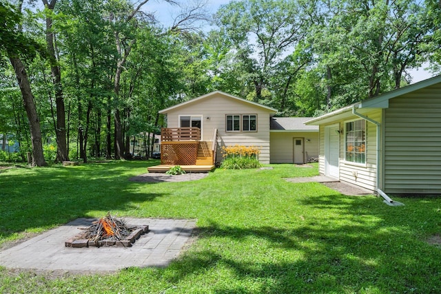 4885 262nd St, Wyoming, MN 55092 - back of house with an outdoor fire pit, a deck, and a lawn