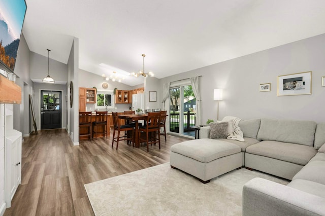 14301 Princeton Ave, Savage, MN 55378 - living room with a chandelier, lofted ceiling, and light wood-style flooring