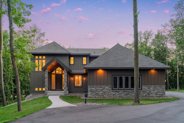 21386 Dorothy Way, Spring Lake Twp, MN 55372 - view of front facade with stone siding, board and batten siding, a shingled roof, and a lawn