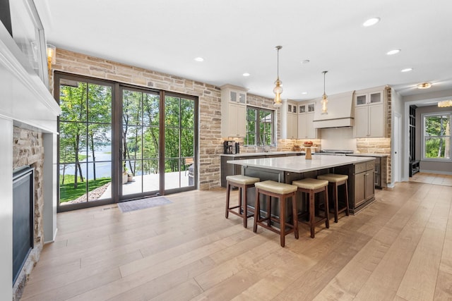 21386 Dorothy Way, Spring Lake Twp, MN 55372 - kitchen featuring light countertops, a stone fireplace, a large island, plenty of natural light, and recessed lighting
