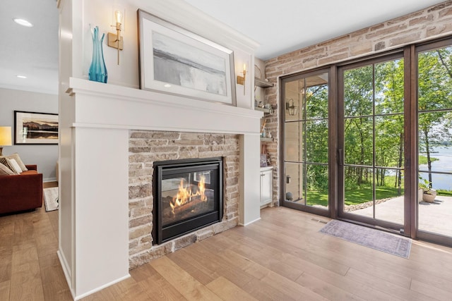 21386 Dorothy Way, Spring Lake Twp, MN 55372 - unfurnished living room featuring wood finished floors, plenty of natural light, a stone fireplace, and recessed lighting