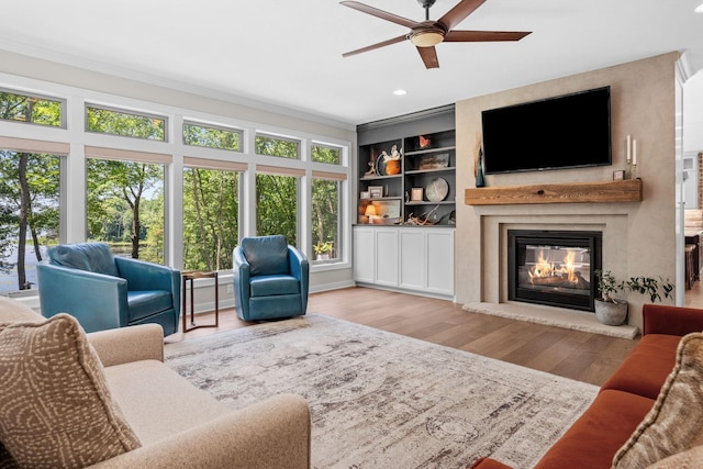 21386 Dorothy Way, Spring Lake Twp, MN 55372 - living area with crown molding, a ceiling fan, wood finished floors, a large fireplace, and recessed lighting