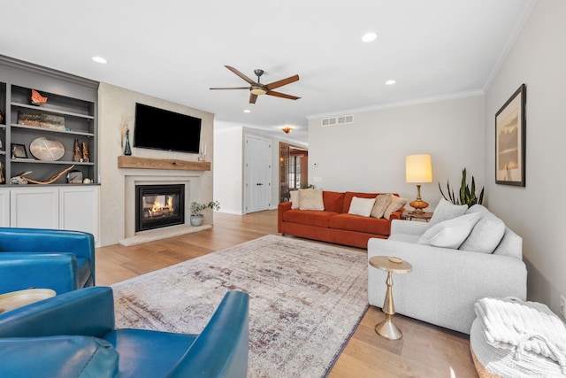 21386 Dorothy Way, Spring Lake Twp, MN 55372 - living room featuring ornamental molding, a ceiling fan, a glass covered fireplace, light wood-style flooring, and recessed lighting