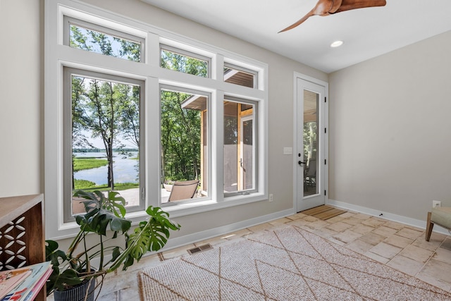 21386 Dorothy Way, Spring Lake Twp, MN 55372 - doorway to outside with healthy amount of natural light, ceiling fan, stone tile flooring, a water view, and recessed lighting