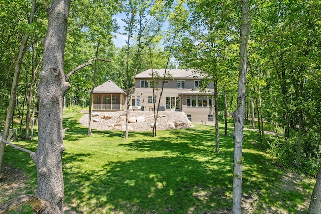21386 Dorothy Way, Spring Lake Twp, MN 55372 - rear view of house featuring a sunroom and a lawn