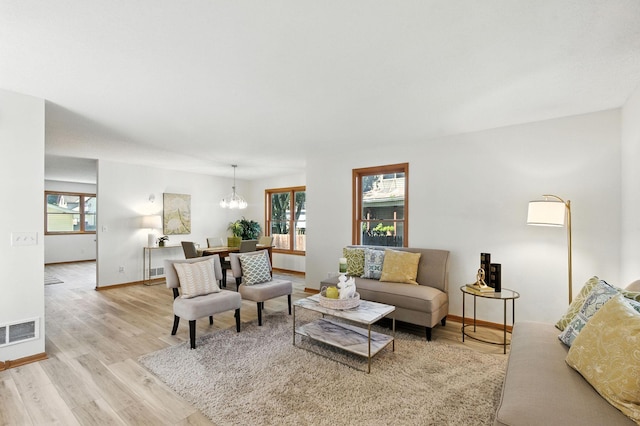 726 Thomas Ave, Saint Paul, MN 55104 - living room featuring wood finished floors and a chandelier