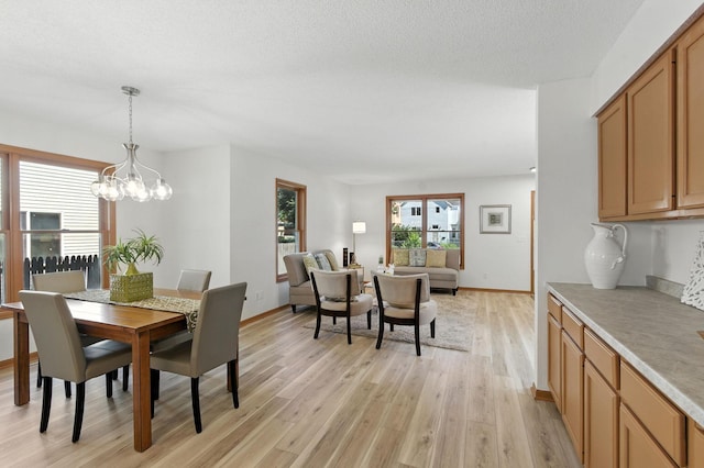 726 Thomas Ave, Saint Paul, MN 55104 - dining room featuring light wood-style floors and a chandelier