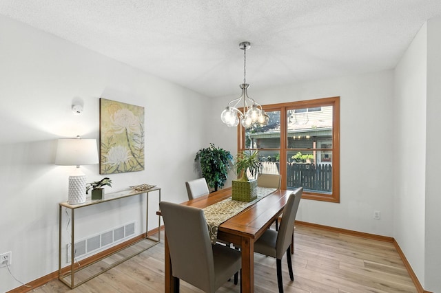 726 Thomas Ave, Saint Paul, MN 55104 - dining area featuring a chandelier and light wood finished floors