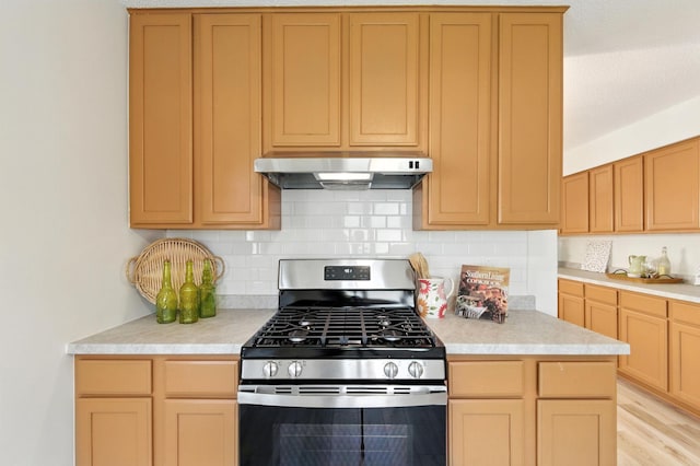 726 Thomas Ave, Saint Paul, MN 55104 - kitchen with stainless steel range with gas cooktop, under cabinet range hood, light countertops, tasteful backsplash, and light brown cabinetry