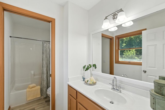 726 Thomas Ave, Saint Paul, MN 55104 - full bathroom featuring vanity, wood finished floors, and shower / bath combo with shower curtain