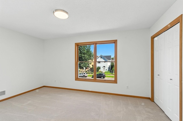 726 Thomas Ave, Saint Paul, MN 55104 - unfurnished bedroom featuring light carpet and a closet