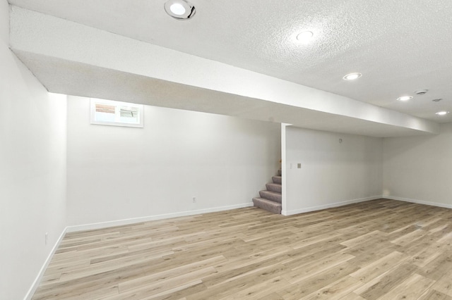 726 Thomas Ave, Saint Paul, MN 55104 - below grade area with light wood-style floors, a textured ceiling, stairs, and recessed lighting
