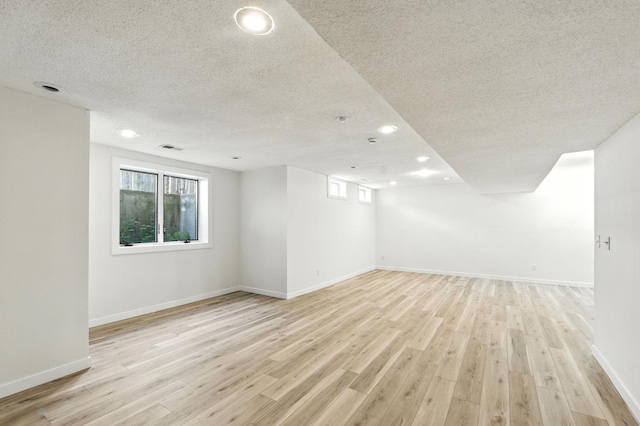 726 Thomas Ave, Saint Paul, MN 55104 - basement with recessed lighting, a textured ceiling, healthy amount of natural light, and light wood-style floors