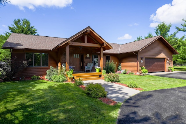 32433 Cedar St, Breezy Point, MN 56472 - view of front facade featuring driveway, an attached garage, a porch, a front yard, and a shingled roof