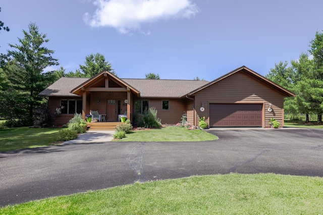 32433 Cedar St, Breezy Point, MN 56472 - single story home with an attached garage, asphalt driveway, a front yard, covered porch, and roof with shingles