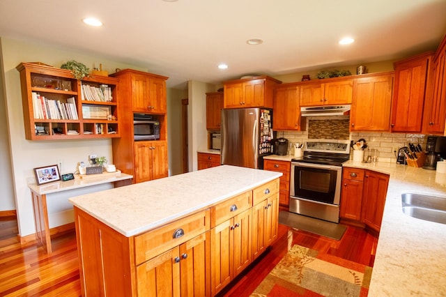32433 Cedar St, Breezy Point, MN 56472 - kitchen featuring appliances with stainless steel finishes, under cabinet range hood, dark wood-style flooring, backsplash, and recessed lighting