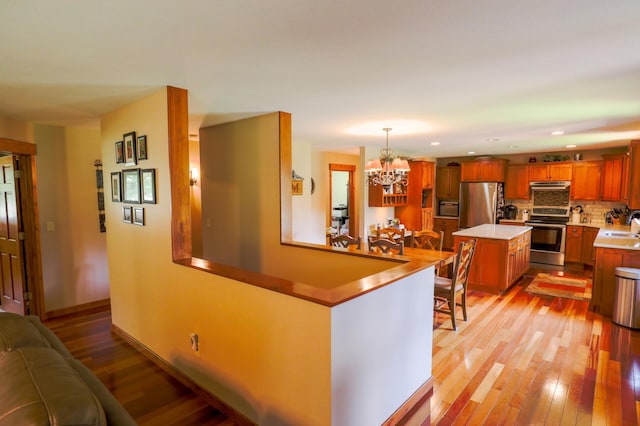 32433 Cedar St, Breezy Point, MN 56472 - kitchen featuring appliances with stainless steel finishes, light wood-style flooring, a chandelier, light countertops, and recessed lighting