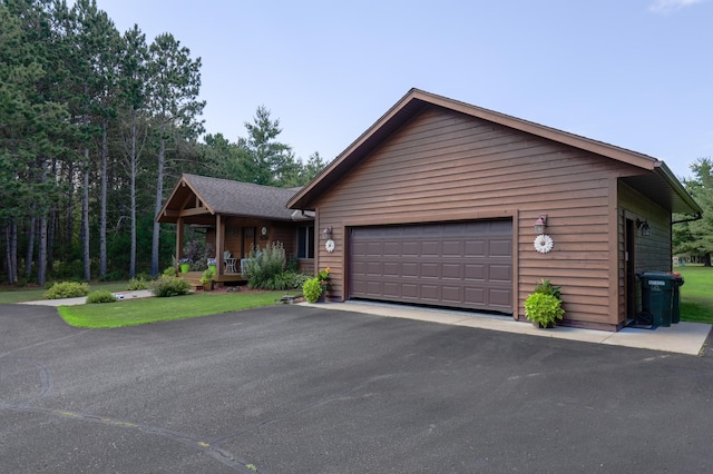 32433 Cedar St, Breezy Point, MN 56472 - view of front facade with a porch, an attached garage, and asphalt driveway