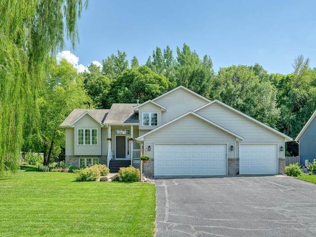 1483 Woods Creek Dr, Delano, MN 55328 - view of front of property with a front lawn, asphalt driveway, an attached garage, and brick siding