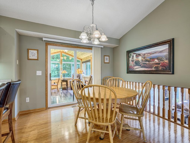1483 Woods Creek Dr, Delano, MN 55328 - dining room with light wood-type flooring, a chandelier, vaulted ceiling, and a textured ceiling