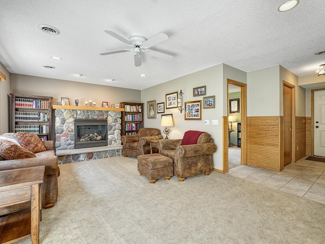 1483 Woods Creek Dr, Delano, MN 55328 - living area with light colored carpet, a ceiling fan, a textured ceiling, a stone fireplace, and recessed lighting
