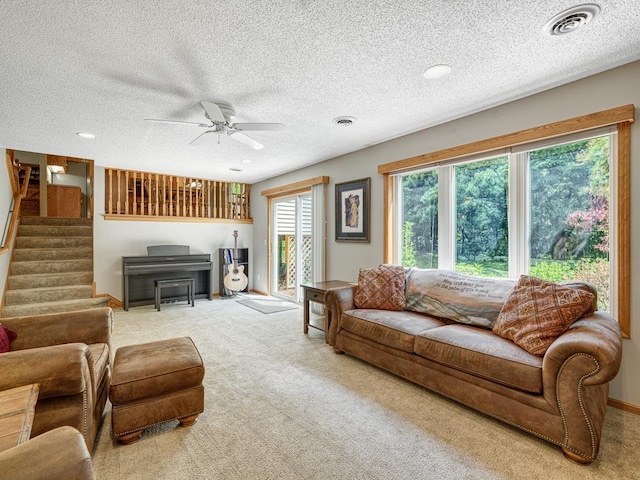1483 Woods Creek Dr, Delano, MN 55328 - carpeted living area featuring stairway, a ceiling fan, and a textured ceiling