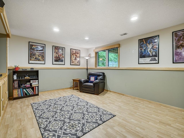 1483 Woods Creek Dr, Delano, MN 55328 - living area featuring wood finished floors, a textured ceiling, and recessed lighting