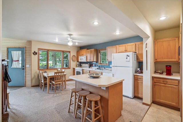 11959 Northgate Ln, Fifty Lakes, MN 56442 - kitchen featuring white appliances, a kitchen breakfast bar, light countertops, ceiling fan, and healthy amount of natural light