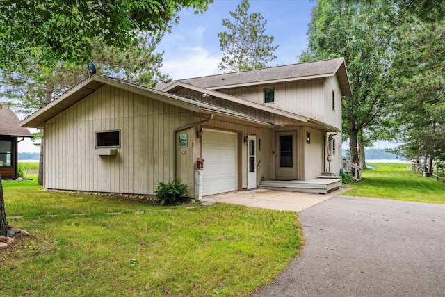 11959 Northgate Ln, Fifty Lakes, MN 56442 - view of front of property featuring asphalt driveway, a garage, a front yard, and a shingled roof