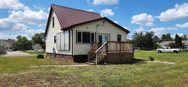 1402 3rd St NE, Staples, MN 56479 - rear view of property with a deck, a lawn, a metal roof, and stairway