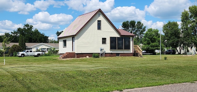 1402 3rd St NE, Staples, MN 56479 - view of property exterior featuring crawl space, a lawn, and a metal roof