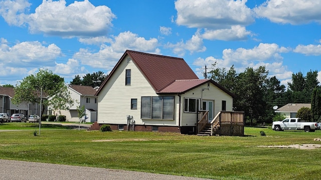 1402 3rd St NE, Staples, MN 56479 - view of side of home with a lawn, a metal roof, and a deck