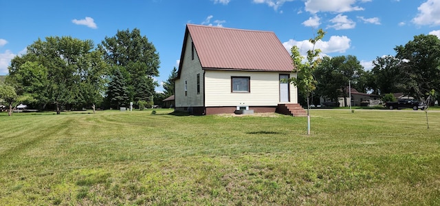 1402 3rd St NE, Staples, MN 56479 - view of property exterior featuring a lawn and a metal roof