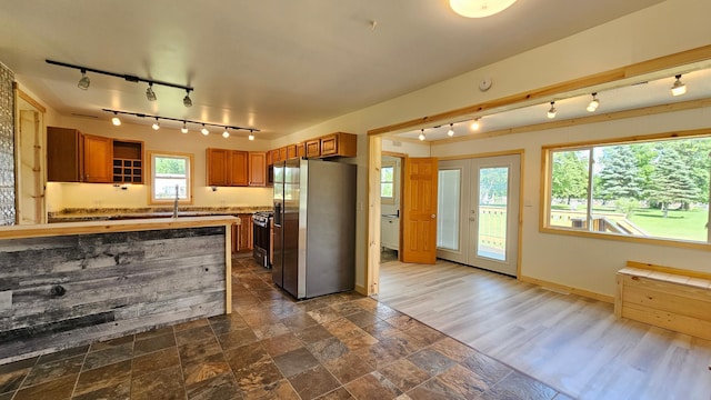 1402 3rd St NE, Staples, MN 56479 - kitchen featuring stainless steel refrigerator with ice dispenser, rail lighting, brown cabinetry, and light countertops