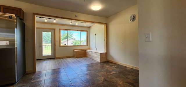 1402 3rd St NE, Staples, MN 56479 - unfurnished room featuring stone tile flooring and rail lighting