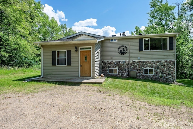 17053 490th St, Shamrock Twp, MN 55760 - view of front facade with stone siding and a front yard
