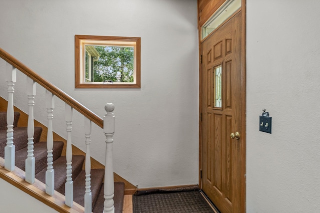 17053 490th St, Shamrock Twp, MN 55760 - foyer entrance featuring stairway, carpet floors, and a textured wall