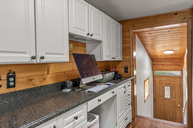 17053 490th St, Shamrock Twp, MN 55760 - kitchen with built in study area, white cabinetry, and wood finished floors
