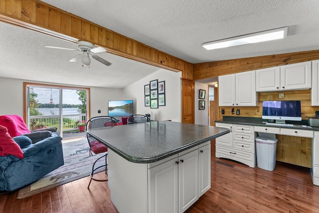 17053 490th St, Shamrock Twp, MN 55760 - kitchen featuring a textured ceiling, open floor plan, dark countertops, white cabinets, and dark wood finished floors