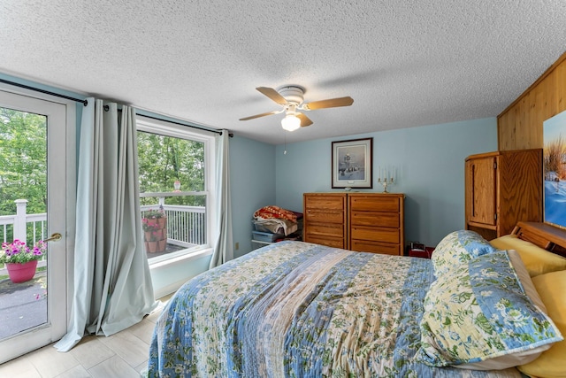 17053 490th St, Shamrock Twp, MN 55760 - bedroom with access to outside, a textured ceiling, and a ceiling fan