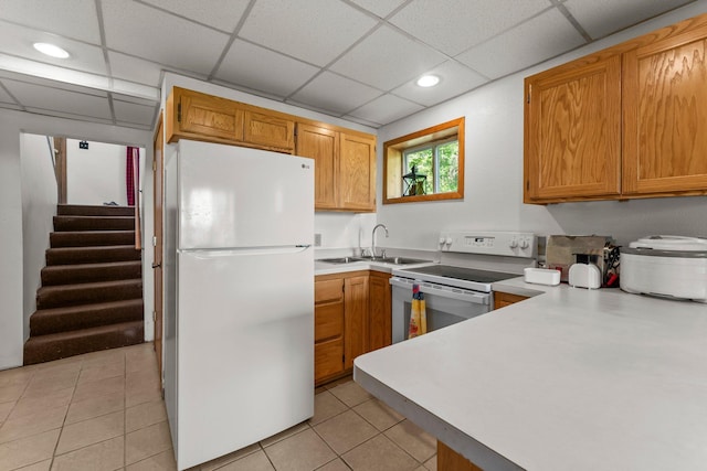 17053 490th St, Shamrock Twp, MN 55760 - kitchen with white appliances, a drop ceiling, light tile patterned flooring, recessed lighting, and light countertops