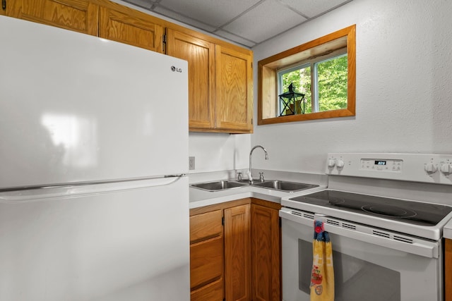 17053 490th St, Shamrock Twp, MN 55760 - kitchen featuring white appliances, light countertops, and brown cabinetry