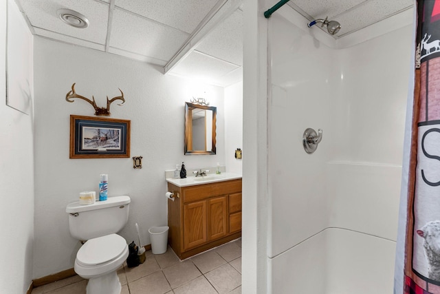 17053 490th St, Shamrock Twp, MN 55760 - bathroom featuring a paneled ceiling, a shower, vanity, and tile patterned flooring