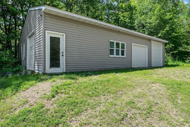 17053 490th St, Shamrock Twp, MN 55760 - view of property exterior with a yard and a detached garage