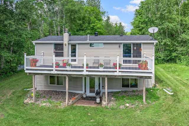 17053 490th St, Shamrock Twp, MN 55760 - back of house with a deck, a yard, a chimney, and a shingled roof