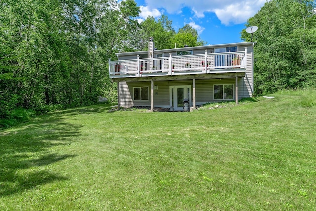 17053 490th St, Shamrock Twp, MN 55760 - back of house with a wooden deck, a yard, and a chimney