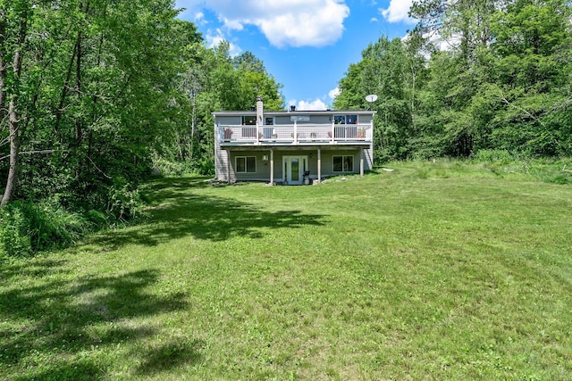 17053 490th St, Shamrock Twp, MN 55760 - back of property featuring a deck, a yard, and a chimney
